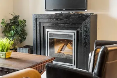 a fireplace with a television on top of it at Aspen Retreat in Invermere