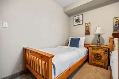 a small bedroom with a bed and a night stand at Aspen Retreat in Invermere