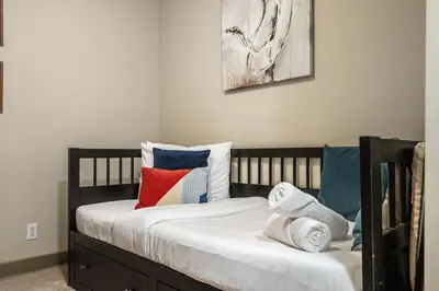 a bedroom with a bed with colorful pillows on it at Aspen Retreat in Invermere