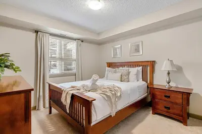 a bedroom with a large bed and a window at Aspen Retreat in Invermere