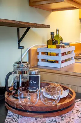 a tray with glasses on a table in a kitchen at Victoria Falls House Inn in Nelson