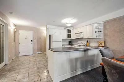 a kitchen with white cabinets and a counter top at Vista in Fairmont Hot Springs