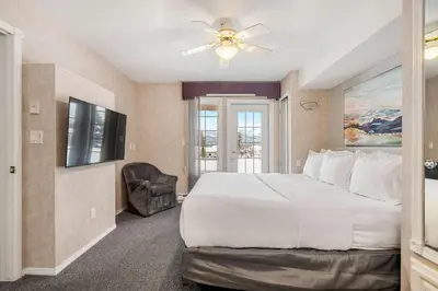 a bedroom with a large bed and a television at Vista in Fairmont Hot Springs