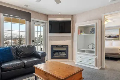 a living room with a couch and a fireplace at Vista in Fairmont Hot Springs