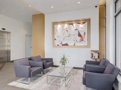 a waiting room with chairs and a painting on the wall at Escher Escape - Art-filled retreat with work desk by Victoria Prime! in Victoria