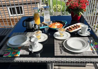 a table with plates of food and a tray of food at Lake and the City Bed and Breakfast in West Kelowna