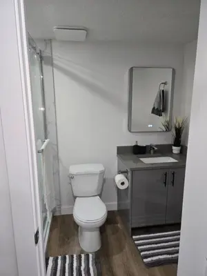 a bathroom with a white toilet and a sink at Staycation3179 in Edmonton