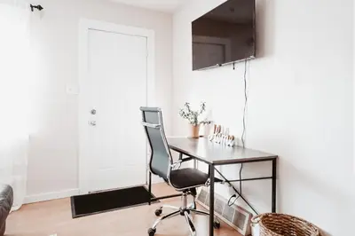 a home office with a desk and a chair at Stay & Play - Central Family Friendly in Calgary