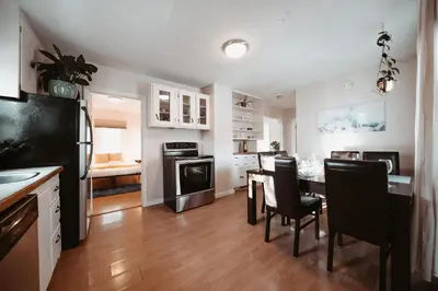 a kitchen and dining room with a table and chairs at Stay & Play - Central Family Friendly in Calgary