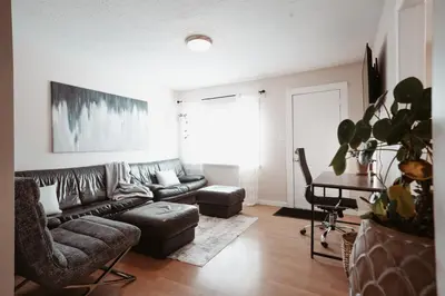 a living room with a couch and a table at Stay & Play - Central Family Friendly in Calgary
