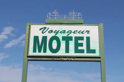 a sign for a vancouver motel in front of the sky at Voyageur Motel in Rocky Mountain House