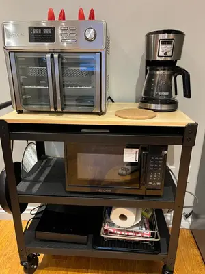 two microwaves and a coffee maker on a shelf at Place near the Coquitlam River Park in Coquitlam