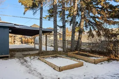 a yard with two raised beds in the snow at Home Alone Retreat in Calgary