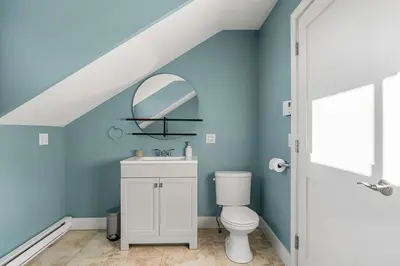 a bathroom with a toilet and a mirror at Home Alone Retreat in Calgary