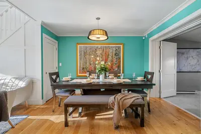 a dining room with a table and a painting on the wall at Home Alone Retreat in Calgary