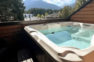 a jacuzzi tub on the roof of a house at Large Village loft with Private Hot Tub and Private Sauna in Whistler