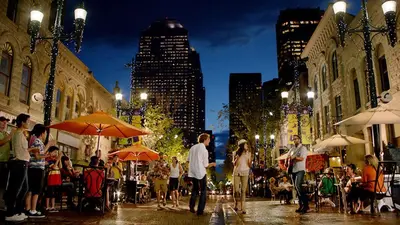 a group of people walking down a city street at night at Near Downtown, Large 3BR! FREE Banff Pass in Calgary