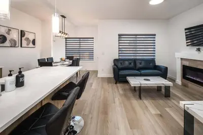 a living room with a couch and a table at Near Downtown, Large 3BR! FREE Banff Pass in Calgary