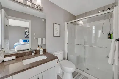 a bathroom with a shower and a toilet and a sink at Luxury family vacation rental in Laurel Edmonton in Edmonton