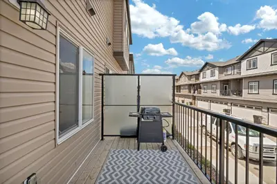 a balcony with a grill on the side of a building at Luxury family vacation rental in Laurel Edmonton in Edmonton