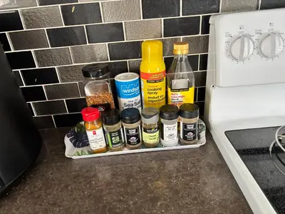 a kitchen counter with a rack of spices and bottles at Luxury family vacation rental in Laurel Edmonton in Edmonton