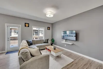 a living room with a couch and a tv at Luxury family vacation rental in Laurel Edmonton in Edmonton