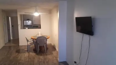 a small room with a table and a television on a wall at Victoria Trail Apartments in Edmonton