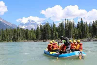 a group of people in a raft on a river at Tete Jaune Lodge in Tete Jaune Cache