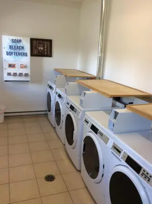 a laundry room with three washing machines in it at Tete Jaune Lodge in Tete Jaune Cache