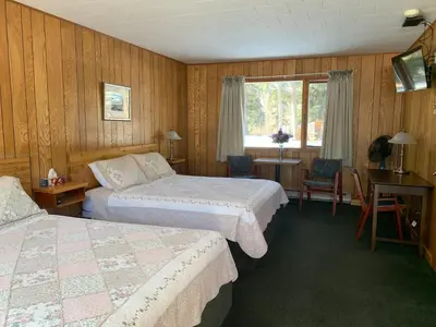 a hotel room with two beds and a window at Tete Jaune Lodge in Tete Jaune Cache