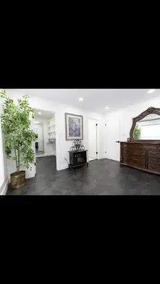 a living room with a plant and a mirror at Modern and luxury 3500 sq feet house jetted tub over 10000 sq feet lot in Edmonton