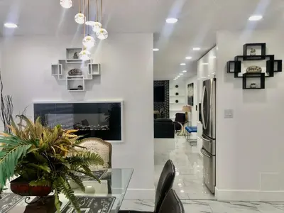 a dining room with a glass table and a fireplace at Modern and luxury 3500 sq feet house jetted tub over 10000 sq feet lot in Edmonton