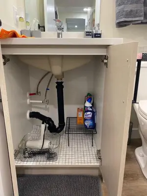a bathroom with a sink with a drain under it at Charming Oasis Tranquil Suite 8 min Airport, AC in Calgary