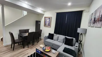 a living room with a couch and a table at Charming Oasis Tranquil Suite 8 min Airport, AC in Calgary