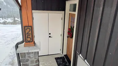 a door with the number on the side of a house at Powder Heights #25 home in Sun Peaks