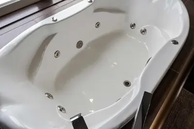 a white bath tub sitting in a bathroom at Luxurious Modern 11-Bed Home Private 136 Acres in Spruce Grove
