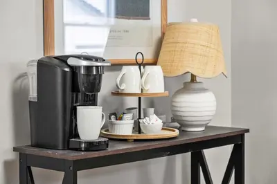 a table with a coffee maker and cups on it at Sylvan Lake Nook Family-Friendly and Close to Beach in Sylvan Lake
