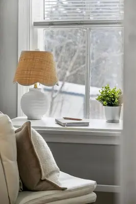 a lamp sitting next to a window with a plant at Sylvan Lake Nook Family-Friendly and Close to Beach in Sylvan Lake