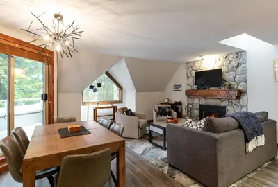 a living room with a couch and a fireplace at 2BR in Gleneagle, Heated Flooring, Wood Burning Fireplace, Shuttle to Gondola in Whistler