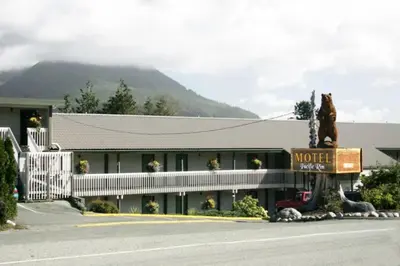 a hotel with a bear statue in front of it at Pacific Rim Motel in Ucluelet
