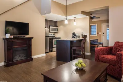 an open living room with a kitchen and a living room at The Castle at Swan Lake in Vernon