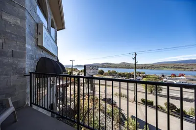 a balcony with a view of a body of water at The Castle at Swan Lake in Vernon
