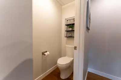 a bathroom with a white toilet in a room at Modern Mountain Oasis Top floor 2 level 2bd in Canmore