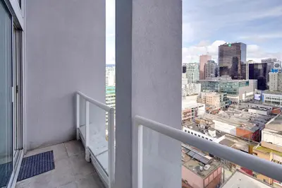 a balcony with a view of a city at Two-Story Loft with a High-rises view and Rooftop Deck in Vancouver