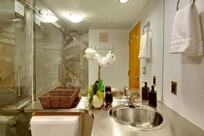 a bathroom with a sink and a shower at Two-Story Loft with a High-rises view and Rooftop Deck in Vancouver