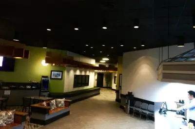a man standing at a counter in a restaurant at Home Away Inn in Drayton Valley