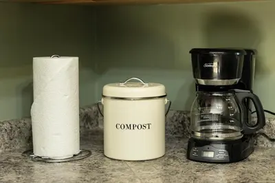 a counter with a coffee maker and a toilet paper roll at Salal Forest - 2 bedroom cabin in the forest in Tofino