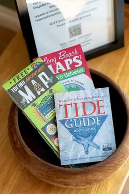 a bowl filled with food and books on a table at Salal Forest - 2 bedroom cabin in the forest in Tofino