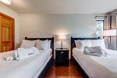 two beds sitting next to each other in a room at Greystone Lodge 224 Ski-in Out in Whistler