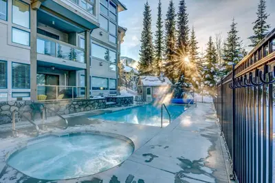a hot tub in the backyard of a house at Greystone Lodge 224 Ski-in Out in Whistler